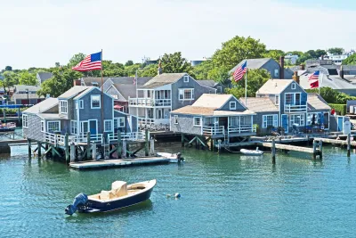 Grey/blue wood homes on docks in Nantucket, Massachusetts.