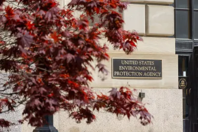 Metal plaque with United States Environmental Protection Agency title on building in Wahsingotn, D.C. with red foliage in the foreground.