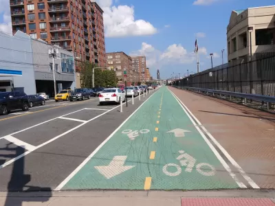 Green painted bike lane with delineators in Hoboken, New Jersey
