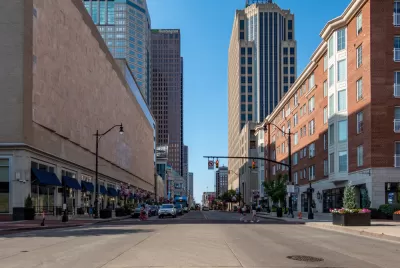 Broad street in downtown Columbus, Ohio with two pedestrians in crosswalk