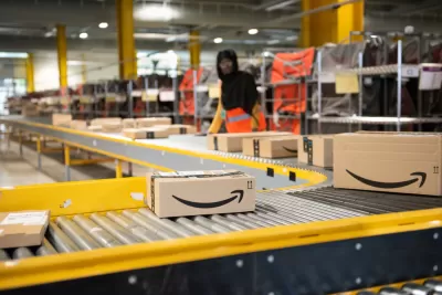 Worker packs boxes in an Amazon warehouse