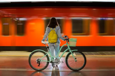 Woman with bicycle on train platform