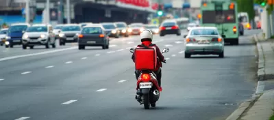 Back view of delivery scooter on roadway