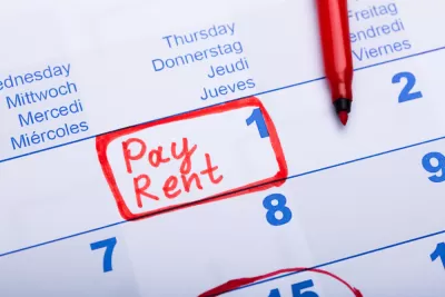 Close-up of calendar on day 1 of month with "Pay Rent" written in red marker