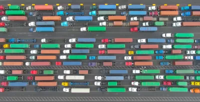 Aerial top-down view of multicolored big rig trucks in lines at the Port of Los Angeles
