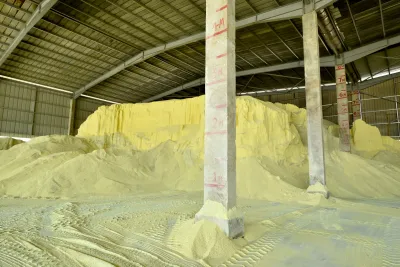 A pile of yellow sulfur in a warehouse