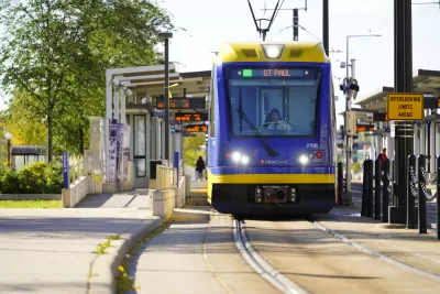 Blue and yellow light rail train pulling into outdoor station in St. Paul, MInnesota