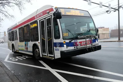 White city bus with red and blue stripes in Philadelphia, Pennsylvania.