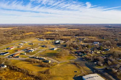 Aerial view of small rural community in Kentucky with ild rolling hills and sparse development