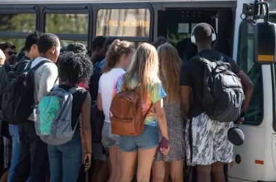 Group of diverse college students boarding crowded bus