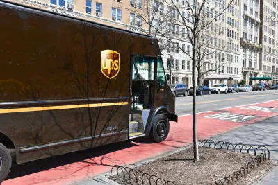 Brown UPS truck stopped in red painted NYC bus lane.