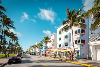 View of Ocean Drive with colorfu three-story buildings and palm trees