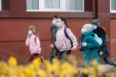 Group of children dressed warmly and wearing COVID-19 masks