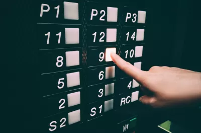 Close-up of black elevator panel qith square white buttons missing 13th floor, person pushing floor 9