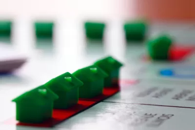 Green Monopoly houses on game board