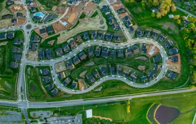 Aerial overhead view of single-family neighborhood with some houses under construction