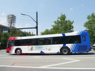 White, blue and red Las Vegas public transit pubs on street.
