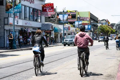 People ride bikes on street in San Francisco, California.