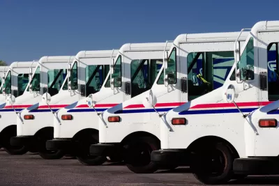 A row of USPS delivery trucks