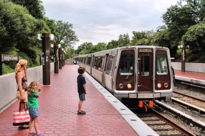 Arlington Cemetery train station platform with woman and young boys waiting as train pulls in.