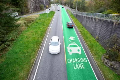 Road with one green electric vehicle charging lane