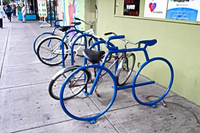 Blue bicycle-shaped bike racks on sidewalk in Las Vegas, Nevada.