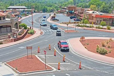 Roundabout with red mulch in middle in Sedona, Arizona with red truck driving through.