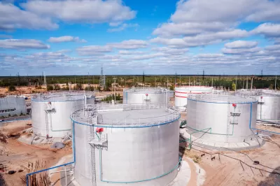 Aerial view of cylindrical silver oil tanks
