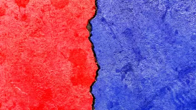 Concrete wall with crack running down the middle painted red on one side and blue on the other
