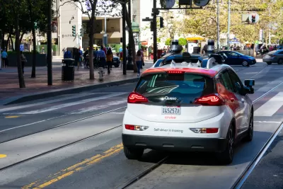Red and white Cruise autonomous Chevy Bolt on San Francisco street