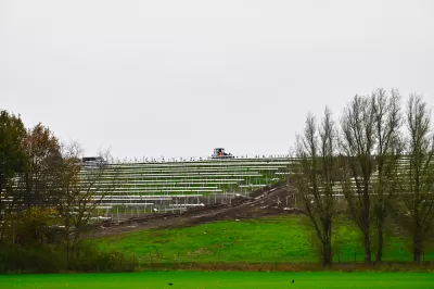 Solar panels on green inclined field on old landfill site in The Netherlands