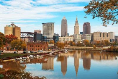 Skyline of Cleveland, Ohio with fall colors reflected in a river.