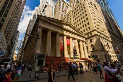New York City, New York - July 29, 2016: View of the Federal Hall at 26 Wall Street in the Financial District with tourists walking on the street.