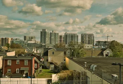 Skyline of Stamford, Connecticut with low-rise multifamily housing in foreground.