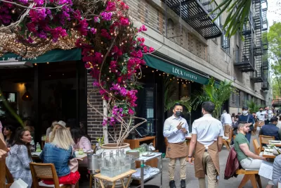 Busy restaurant seating on New York City sidewalk during COVID-19 pandemic