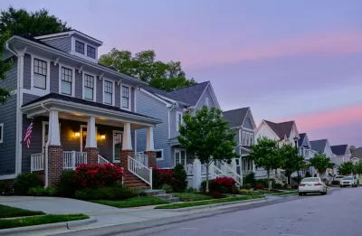 View of houses on small street in Raleigh, North Carolina against a sunset sky
