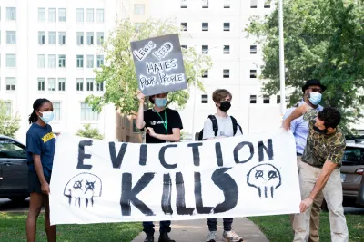 SAINT LOUIS, MO. - August 2, 2021: Protestors hold a banner that reads "Eviction Kills" at an "End Eviction" protest opposing the end of the federal eviction moratorium.
