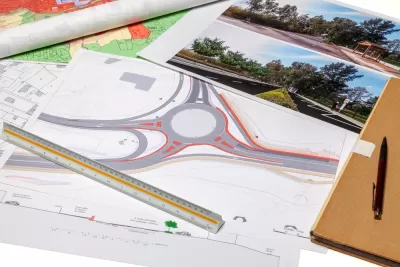 Diagram of a roundabout and site photos laid out on a desk
