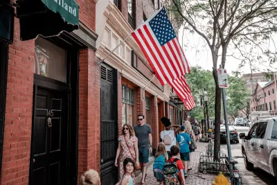 A crowd of people walking down a street in Boston
