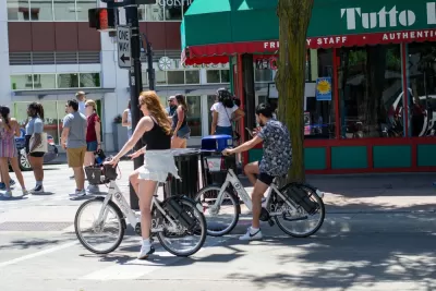 People riding electric bike share bikes in downtown Madison, Wisconsin
