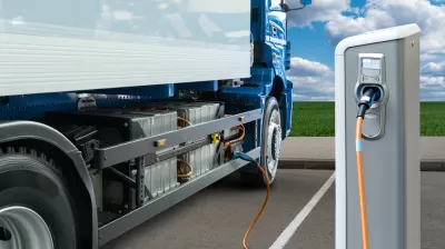 Electric big rig truck plugged into charging station