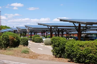 Solar panels shading cars in parking lot in Avignon, France