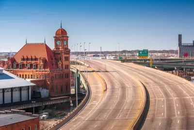 View of empty multi-lane freeway next to historic brick buildingin Richmond, Virginia
