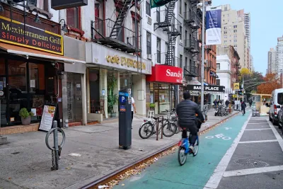Person riding in green painted bike lane in New York City.