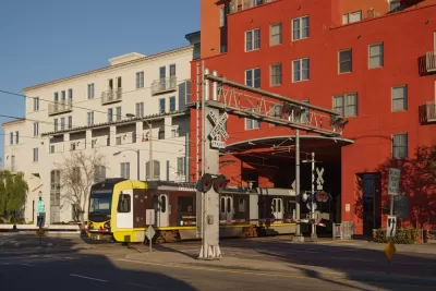 Light rail train passing under apartments in Pasadena, California