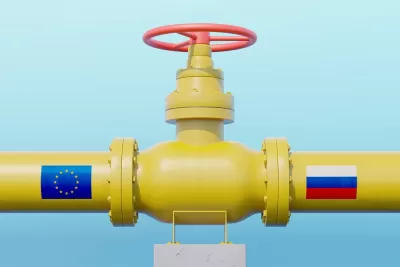 Yellow gas pipeline with E.U. flag on one side and Russia flag on the other side