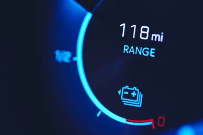 Close-up of car dashboard with 118 mi range.
