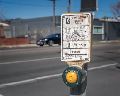 Close-up of pedestrian crossing button at a crosswalk in Los Angeles