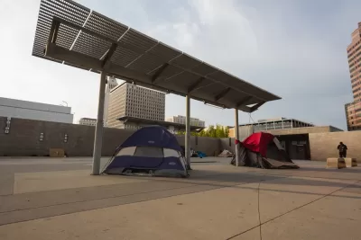 Unhoused tents under shade canopies in downtown Los Angeles, California