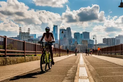 Bike on bridge in Minneapolis with skyline in background